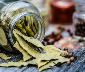 Bay leaves in a jar about to be used to make bay leaf tea for weight loss.