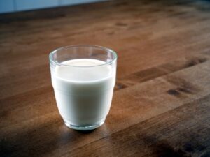 A glass of milk being consumed as part of a healthy weight loss diet.