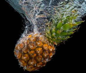 A pineapple in water as an example of how you can drink pineapple for weight loss.